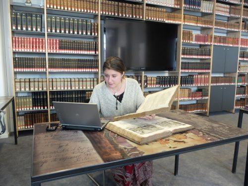 Angelica looks up the modern place names of location in the Kircher book.