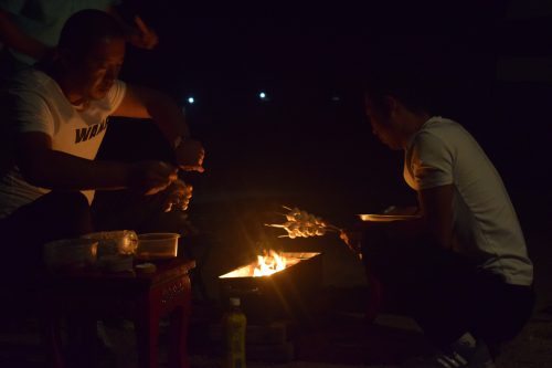 Some locals barbecuing meat in the evening
