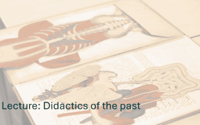 Anatomical human body model displayed on open book for educational purposes.