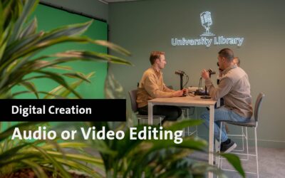 Two men recording audio in Maastricht University Library studio for video editing.