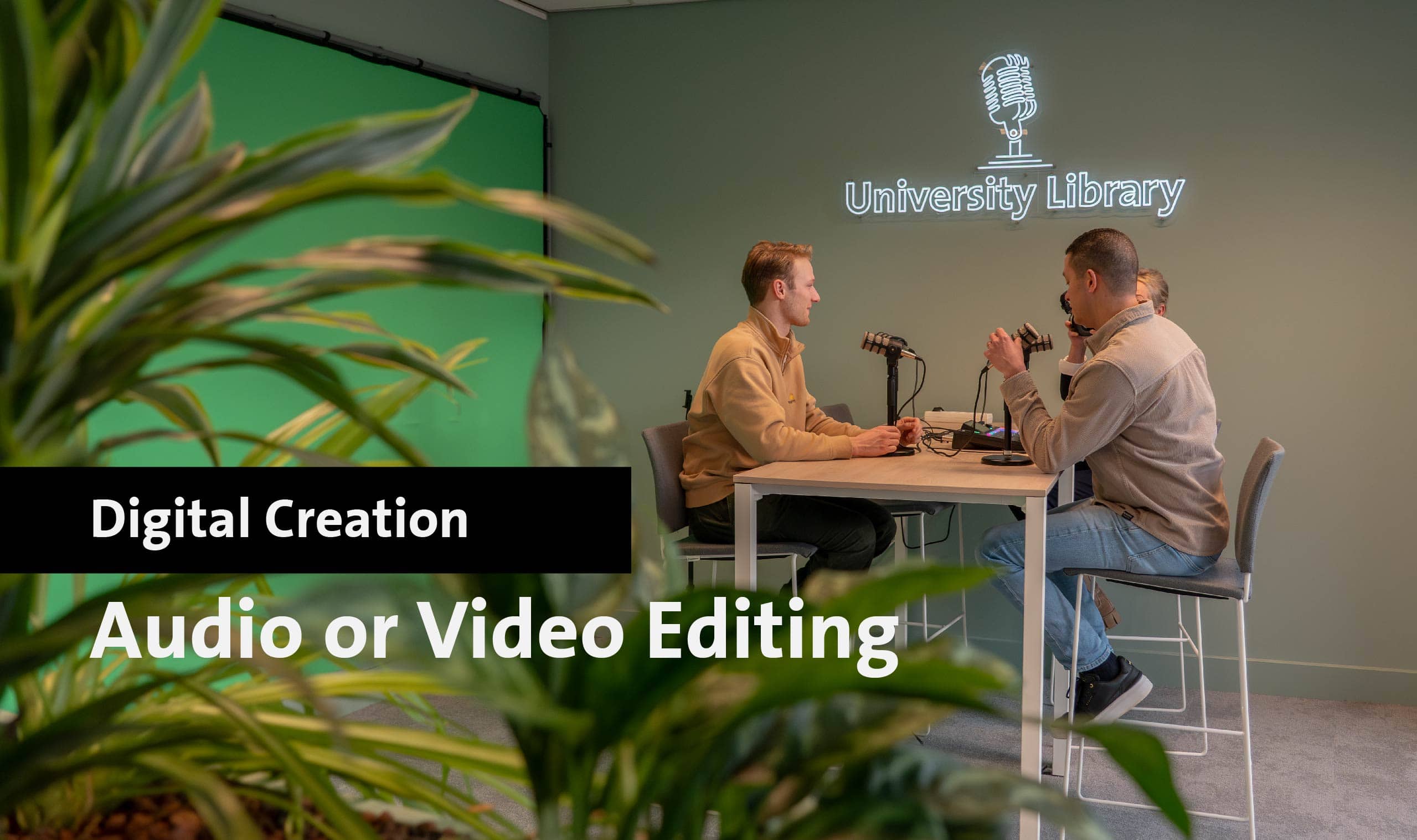 Two men recording audio in Maastricht University Library studio for video editing.