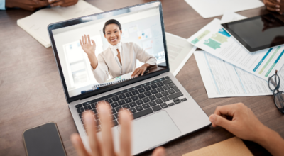 laptop showing a woman waving