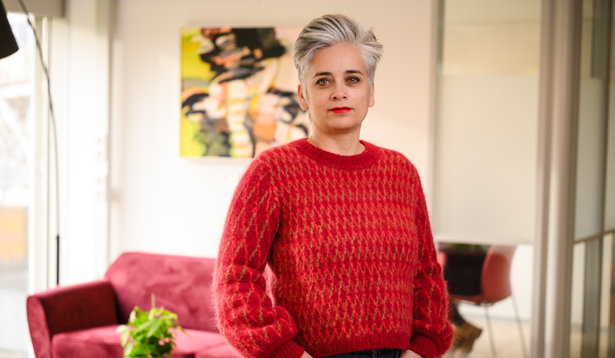 profile pic of a woman wearing a red jumper