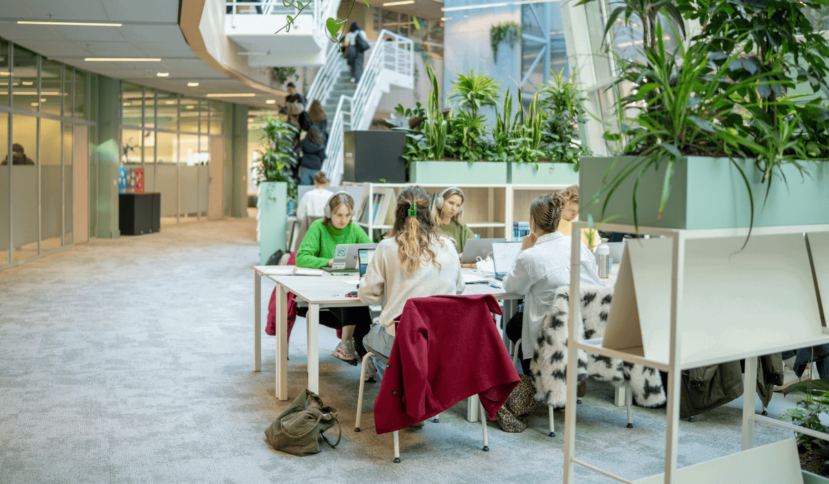 Students collaborating at a table in Maastricht University Library.