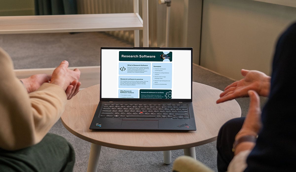 A laptop screen displays the infographic about FAIR research software.