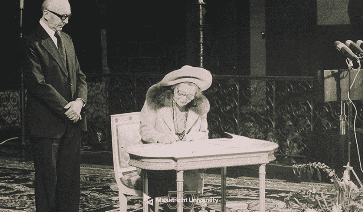 Historical photo of a woman signing a document at Maastricht University Library.