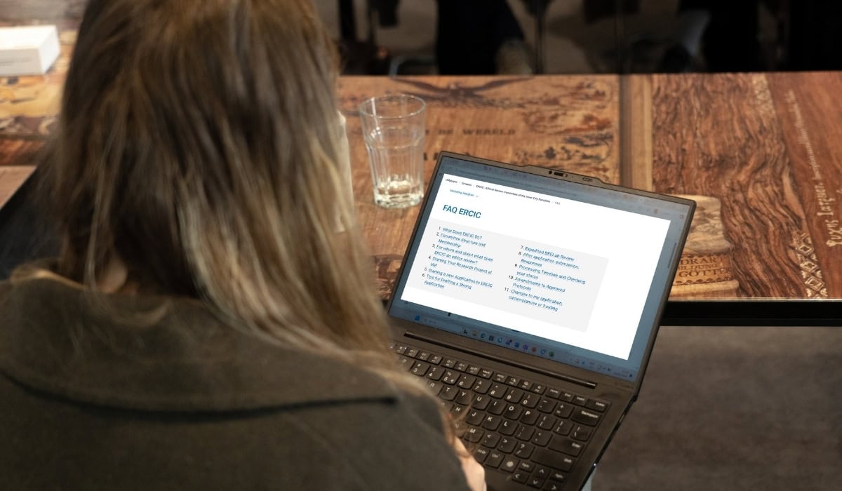 A woman studying on a laptop at Maastricht University Library.