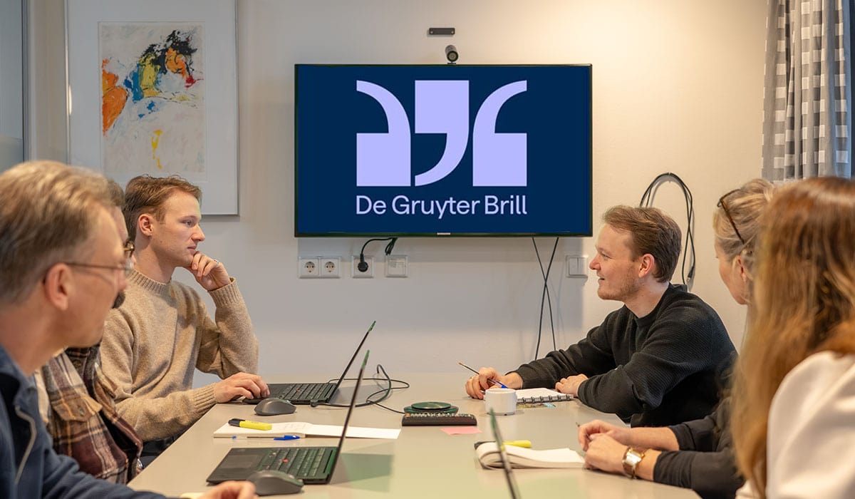 De Gruyter Brill logo displayed on a TV screen during a professional meeting at Maastricht University Library.