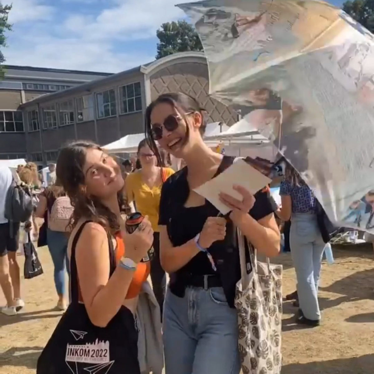 happy students with the library umbrella