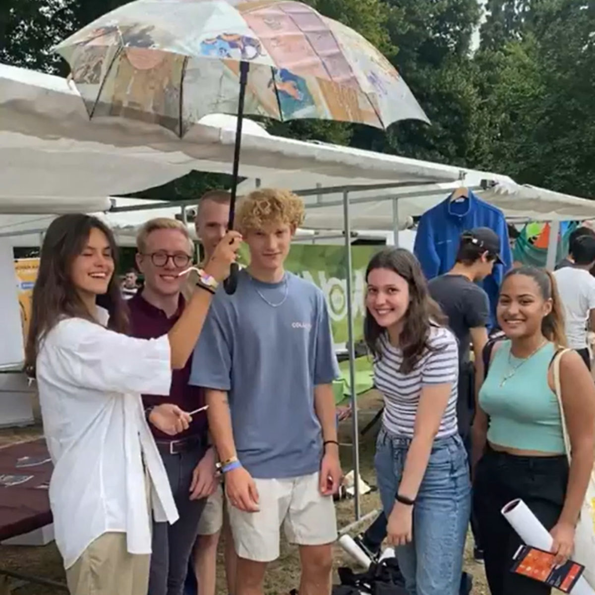 a group picture of students with the library umbrella