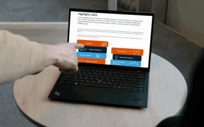 Person pointing at research highlights on a laptop screen at Maastricht University Library.