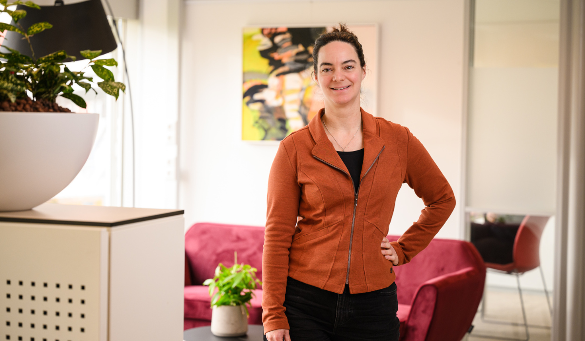 profile pic of a woman wearing a brown zipper vest