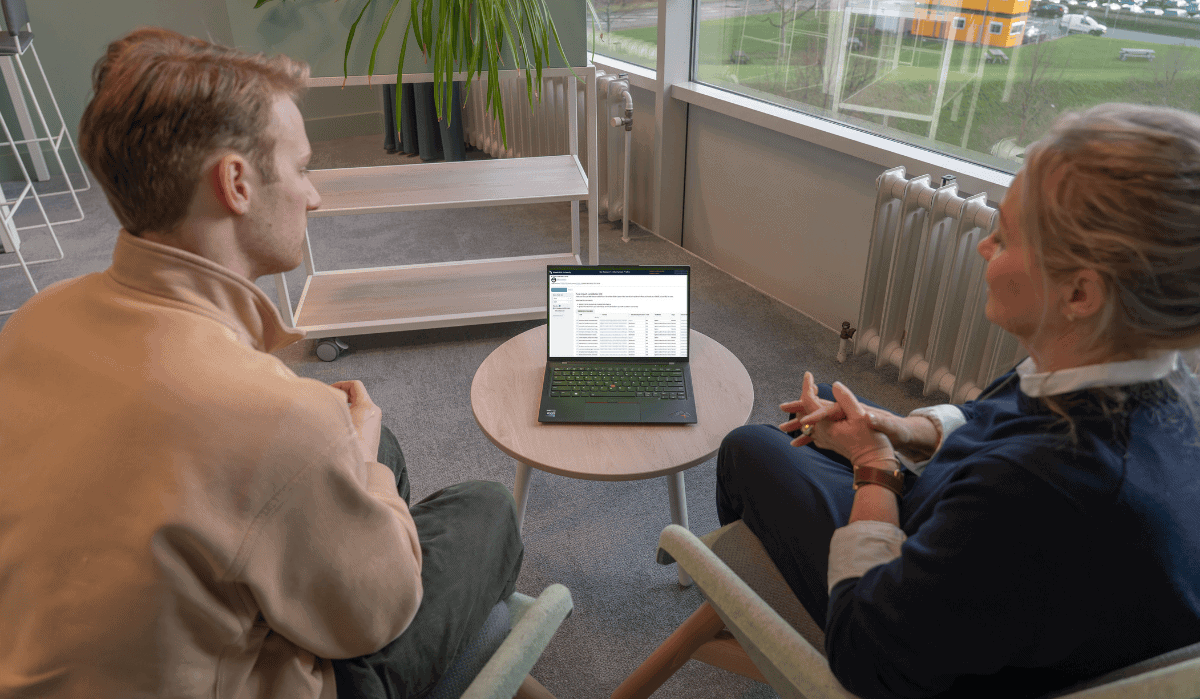 Two people discussing datasets and software on a laptop at Maastricht University Library.