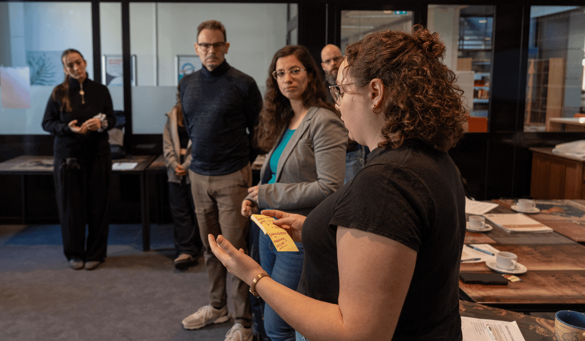 Maastricht University Library staff discussing in a modern study area.