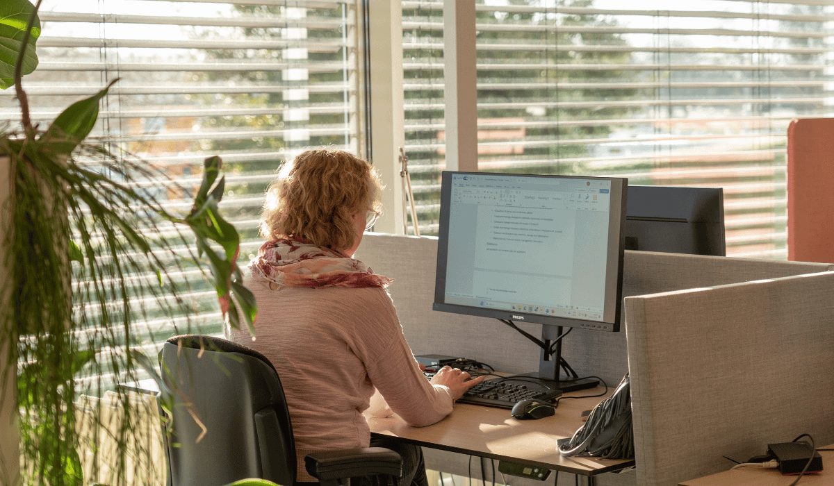 Person working on a computer at a desk.