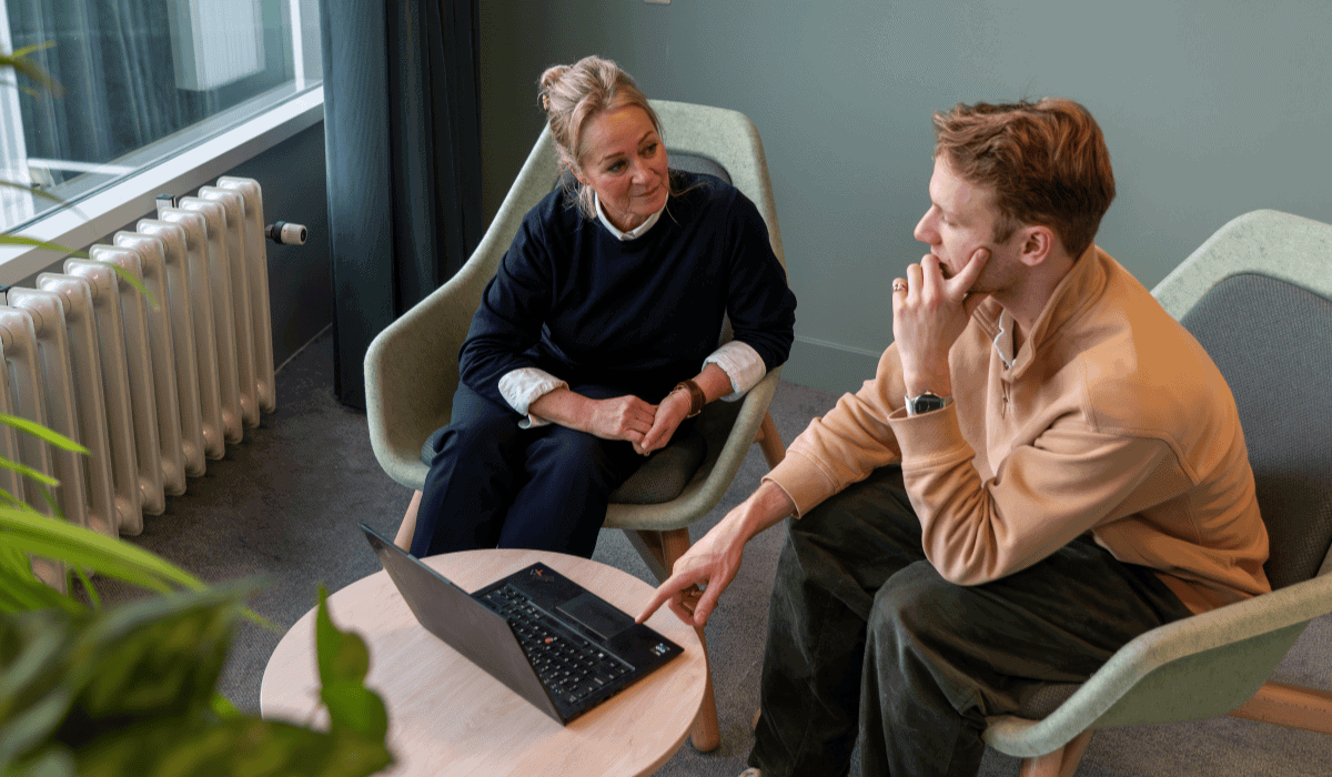 Two researchers discussing open science recognition in a modern office setting.