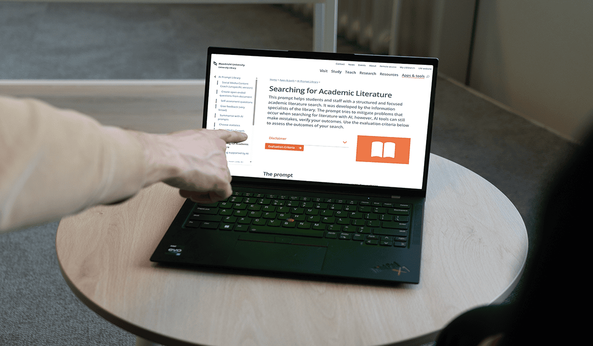 Person using a laptop to search for academic literature online.