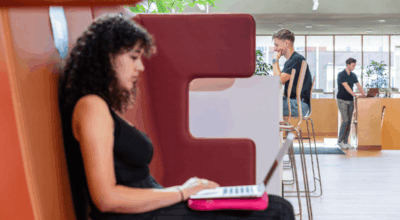 Photo of students working on laptop