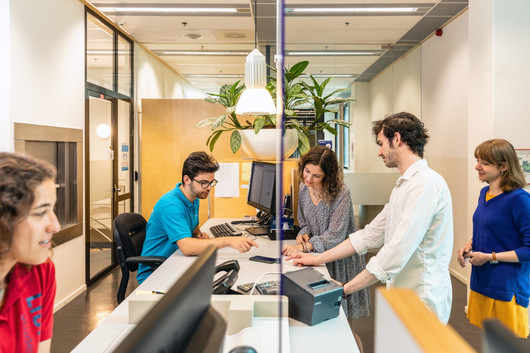 students at the library information desk