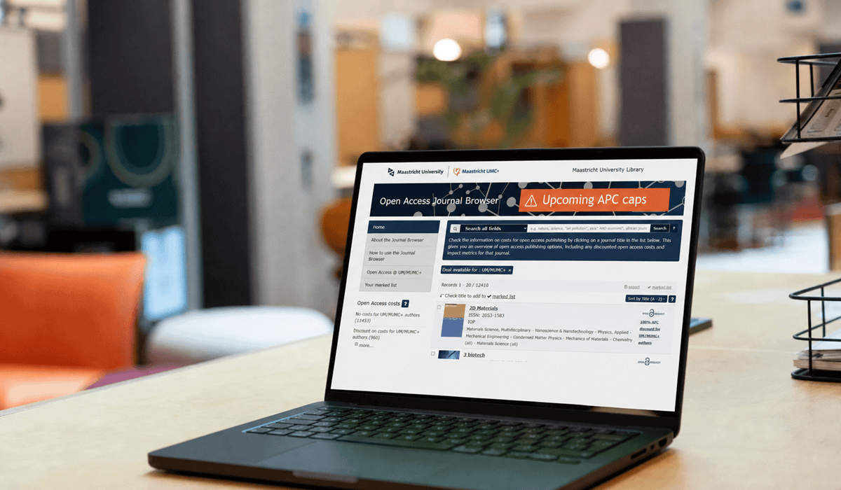 Laptop displaying Maastricht University Library's open access journal browser.