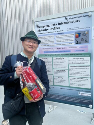 Shuai Wang posing in front of Most Innovative Poster at the Open Science Festival 2025