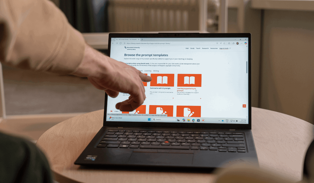 Person browsing digital library resources on a laptop at Maastricht University.